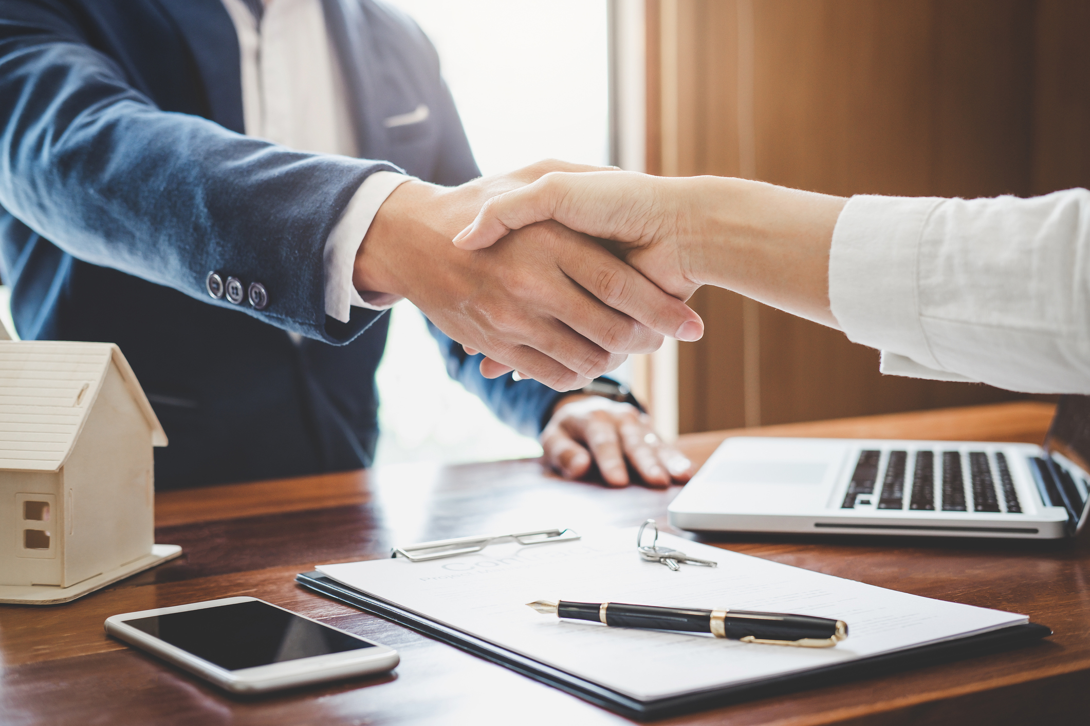 Real estate agent and customers shaking hands together celebrating finished contract after about home insurance and investment loan, handshake and successful deal 3 Keys to Successfully Selling Your Business